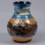 A Moorcroft pottery vase. With stylised scene of streams and rocks, etc. Impressed marks etc to