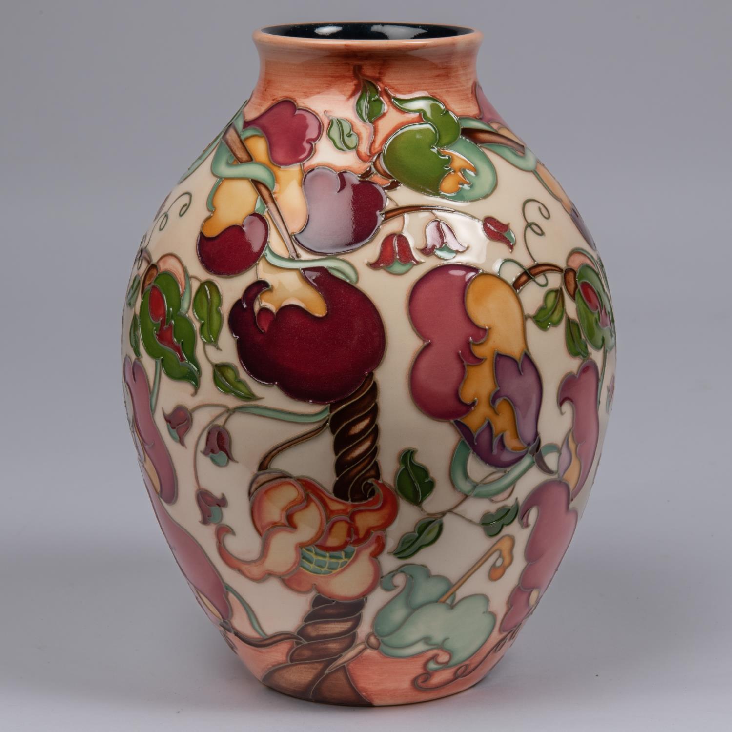 A Moorcroft pottery vase. With a stylised mixed floral design. Marks to base, pineapple date