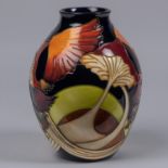 A Moorcroft pottery vase. Stylised mushroooms on a dark blue ground. Marks to base, JS, Q date