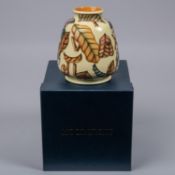 A Moorcroft pottery vase. With autumn leaves and Roman numerals on yellow ground. Marks to base,