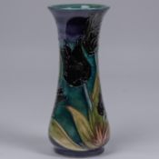 A Moorcroft pottery vase. Black tulips on a sea-green and purple ground. Impressed marks to base,