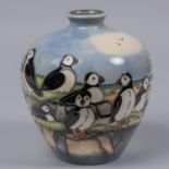 A Moorcroft pottery vase. With puffins standing on a clifftop scene designed by Kerry Goodwin. Marks