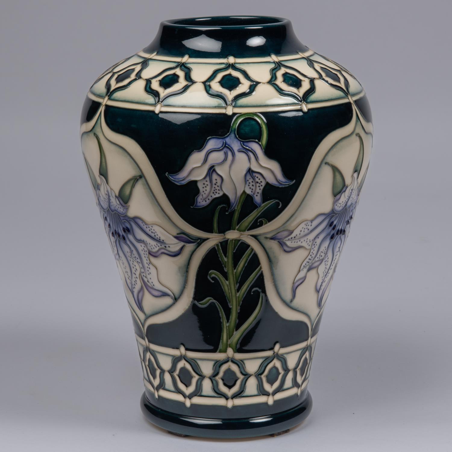 A Moorcroft pottery vase. With lily design on dark blue ground by Marie Penkethman. Impressed - Image 2 of 3