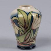A Moorcroft pottery miniature vase. With stylised floral design. Marks etc to base dated 2005 with
