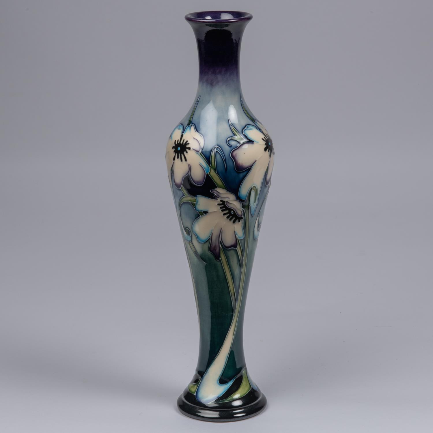 A Moorcroft pottery slim vase. Blue tinged white flowers on a graded green and blue ground. Marks to - Image 2 of 3