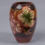 A Moorcroft pottery vase. Galdioli type blooms on a graded ground. Marks to base, GP, bell date
