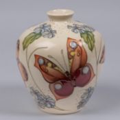 A Moorcroft pottery vase. With butterfly designs. Marks etc to base. H.170mm GC, some crazing to