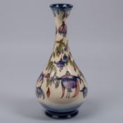A Moorcroft pottery vase from 2001. With fuchsia design in purple. Impressed marks etc to base