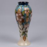 A Moorcroft pottery vase. Pale straberries on a cream and blue ground. Marks to base, pineapple date