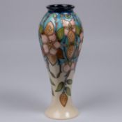 A Moorcroft pottery vase. Pale straberries on a cream and blue ground. Marks to base, pineapple date