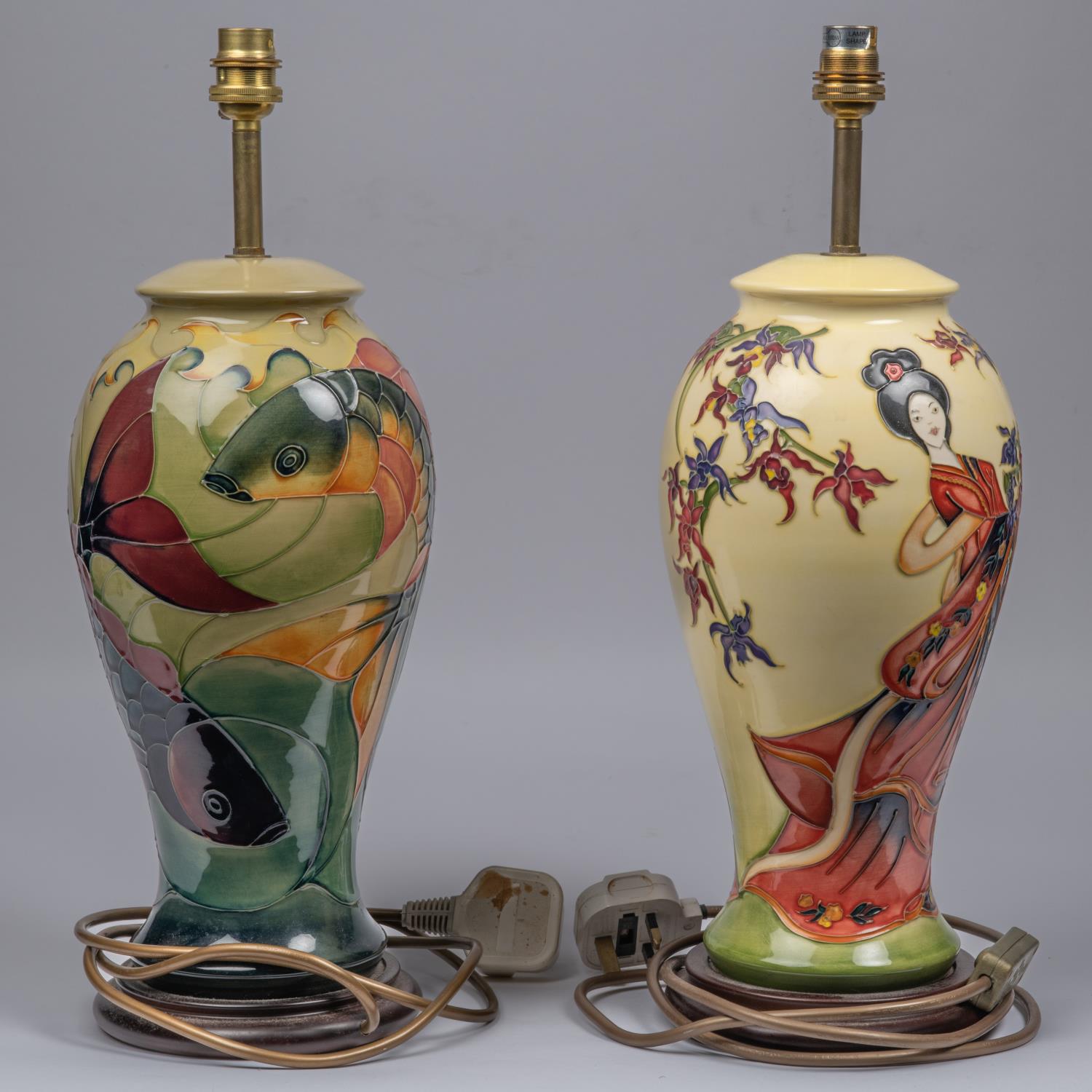 Two Moorcroft pottery lamp vases. One with a Japanese scene and one with a fish design. Overall