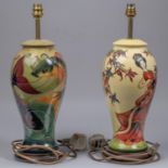 Two Moorcroft pottery lamp vases. One with a Japanese scene and one with a fish design. Overall