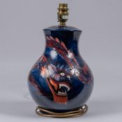 A Moorcroft pottery lamp vase. With Chinese dragon on dark blue ground. Impressed marks to base. H.