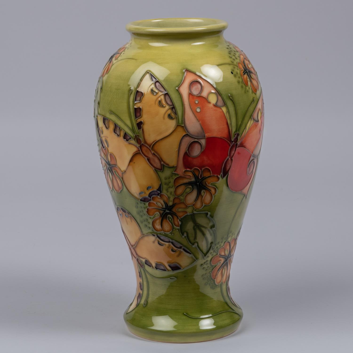 A Moorcroft pottery vase from 1994. A trial piece with butterfly designs. Marks etc to base with eye