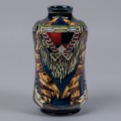 A Moorcroft pottery vase. With Native American decoration on dark blue ground. Marks to base, PH,