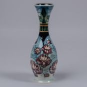 A Moorcroft pottery slim vase. Water liles in a landscape on a graded blue ground. Impressed marks
