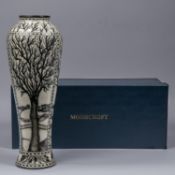 A Moorcroft pottery tall vase. Leafless trees with mushrooms around the bases in black and white