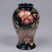 A Moorcroft pottery vase. Trial vase flowers on a graded ground. Marks to base, MP, diamond date