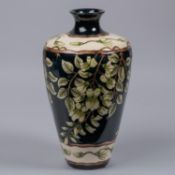 A Moorcroft pottery large vase. With wisteria on a dark blue and cream ground. Marks to base, signed
