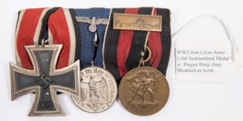 A German Third Reich medal trio: 1939 Iron Cross 2nd class, 4 year Long Service medal, and medal for