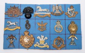 Fourteen military cap badges, including Royal Scots Greys, 8th Hussars, 12th Lancers, 27th