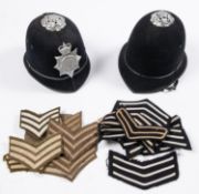 A post 1953 British Transport Police helmet, with chromed mounts; another similar (badge missing); a
