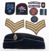 A blue side cap of the Royal Corps of Signals; a Combined Operations red on black circular cloth