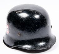 A Third Reich steel police helmet, painted black with replacement decals, lining and chinstrap.