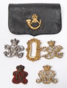 A Victorian bullion embroidered crowned "VR" forage cap badge; a gilt pouch badge with crowned