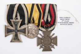 A German WWI medal trio: 1914 Iron Cross 2nd class, Wurttemberg silver Merit medal, and 1914-18