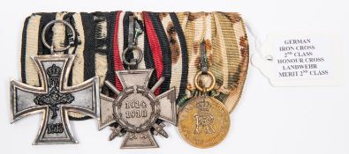 A German WWI medal trio: 1914 Iron Cross 2nd class, 1914-18 Honour Cross, and Reserve Landwehr medal