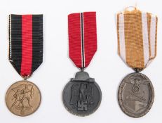 Third Reich medals: Russian Front medal, 1941-42; West Wall medal; and medal for 1st October 1938,