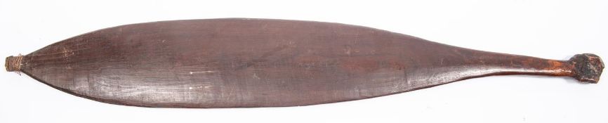 An Australian aborigine wooden spear thrower "wommera", 25" overall, of slightly concave spatulate