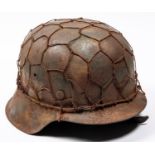 A Third Reich M1943 raw edge pattern steel helmet, in combat condition, traces of SS decal, wire
