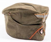 A Third Reich DAK Mans FS cap, olive green denim with embroidered insignia, dated 1943, GC £400-450