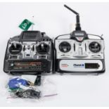 2 hand-held radio control units. A Planet T5 advanced 2.4GHZ, no instructions and the other a