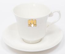 A Third Reich china cup and saucer with gilt eagle and swastika flanked by "AH", made by Allach,