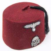 An officer's fez, lining marked with crescent and stars, modern replica SS badges affixed. GC £60-80