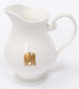 A Third Reich china milk jug with gilt eagle and swastika flanked by "AH", made by Allach. VGC £