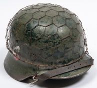 A Third Reich double decal M40 steel helmet, with state shield and army eagle, leather liner with