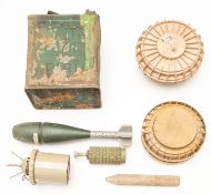 A post WWII mortar bomb, 3 plastic cased land mines and one other segmented projectile and a 2