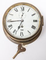 A brass bodied bulkhead/ship's clock, by Sestrel, Roman numerals, with regulator slot above