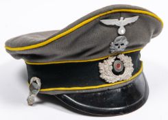 A well made copy of a Third Reich cavalry officer's peaked cap, grey with yellow piping, alloy