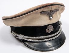 A Third Reich SS officer's tropical peaked cap, white drill body, alloy eagle and skull badges,