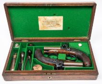 A good pair of Irish double barrelled side by side 34 bore percussion travelling pistols, by Bowls