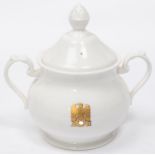 A Third Reich china sugar bowl with lid, marked with gilt eagle and swastika flanked by "AH", made