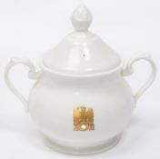 A Third Reich china sugar bowl with lid, marked with gilt eagle and swastika flanked by "AH", made