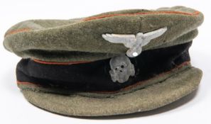 A good quality copy of a Third Reich Waffen SS peaked cap, field grey with alloy badges. GC £300-350