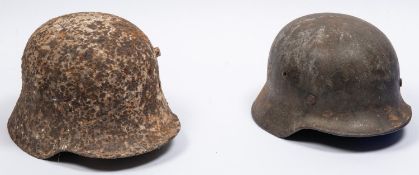 A Third Reich M1935 steel helmet, traces of decal on left side, QGC (quite pitted); a Model 1916 WWI