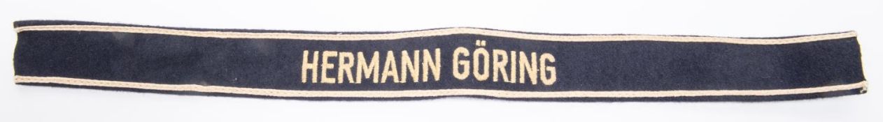 A Third Reich Hermann Goring cuff title, white embroidery border on black, cream lettering. GC £60-